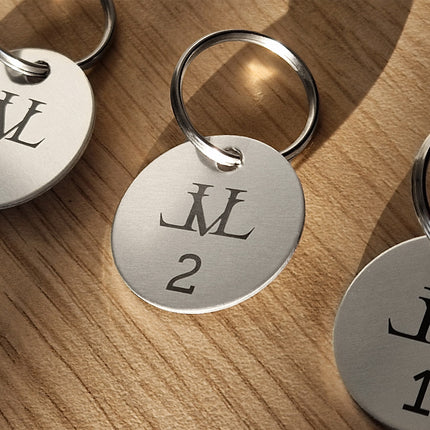 Silver aluminum key tag with number and logo